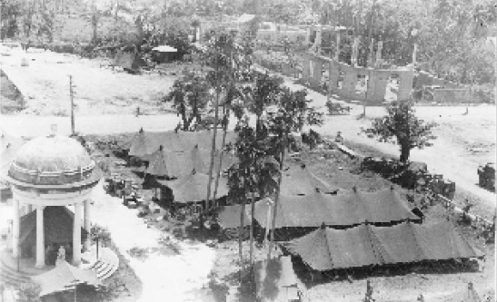 99th Evacuation Hospital operations in the plaza at Molo, Panay, Philippine Islands. Apparently taken from the damaged bell tower of Santa Ana’s Catholic Church between July 31 and September 9, 1945. (First Sergeant Elmer R. Young collection).
