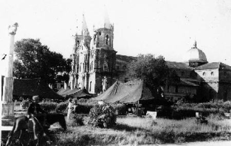 Ward tents of the 99th Evacuation Hospital in the plaza at Molo, Panay, Philippine Islands sometime between August and September 1945. (First Sergeant Elmer R. Young Collection).