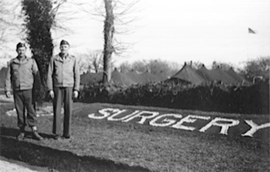Partial view of the Surgery Section of the 164th General Hospital. Row of tents in the background. The person on the left is 1st William E. Sheffield with a fellow Officer. Picture courtesy Robert Sheffield