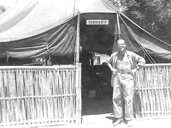 Technician 3d Grade Glenn E. Turner, in front of the unit's "Surgery" tent.