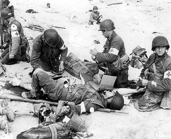 Medical personnel of the 4th Infantry Division treat a wounded fellow medic on Utah Beach. This photograph, taken on 6 June 1944, clearly shows this idiosyncratic Bag. 