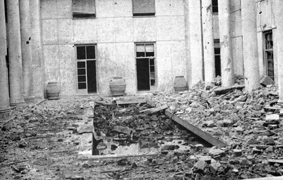 Photograph showing the Building A courtyard. The destruction and devastation caused by the bombing can be seen clearly.