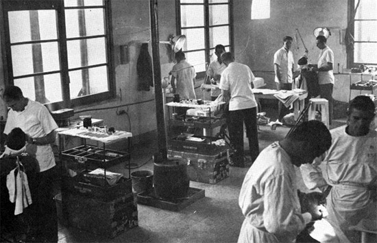 Dentists of the 45th General Hospital hard at work in the Dental Clinic, Naples, Italy. Photograph taken in 1945.