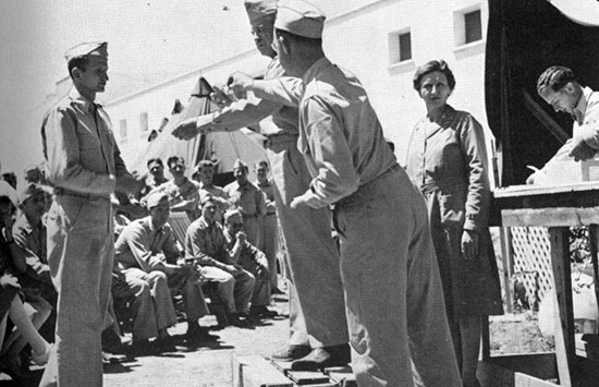 European-African-Middle Eastern Campaign Medals are awarded to members of the 45th General Hospital by Commanding Officer Col. Pfeffer.
