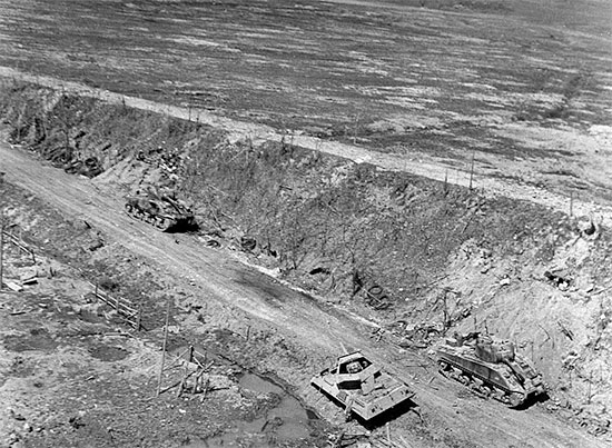 Partial view of the main road leading from Anzio to Rome. Several wrecks of wrecked Allied armor are visible. 