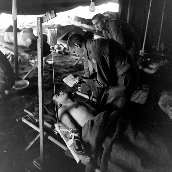 Anzio Beachhead. Fifth United States Army Chaplain comforting or giving last rites to a patient in one of the US hospitals established on the beachhead.
