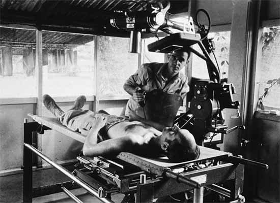 Photograph showing x-ray procedure at the 1st Field Hospital, Milne Bay, New Guinea