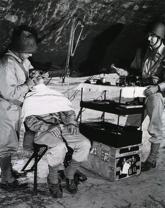 Photograph showing a Dental Clinic established under a Large Wall Tent flysheet during training operations in the Zone of Interior. 