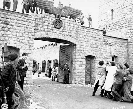 KZ Mauthausen, Austria, Prisoners pull down German eagle with swastika at the entrance of the Concentration Camp, 6 May 1945.