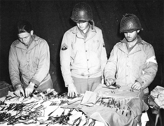 Medical personnel of the 326th A/B Med Co preparing their instruments while at Hiesville, Normandy, early June 1944.