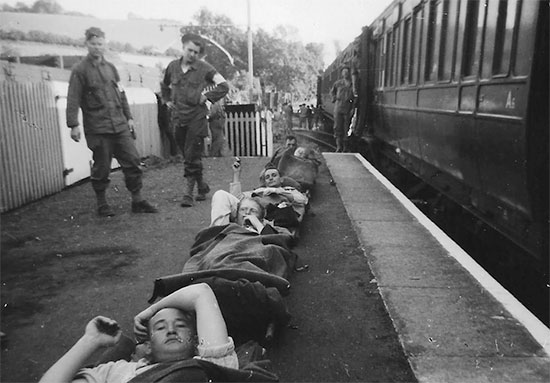 Photograph illustrating 11th Hospital Train personnel with patients in Templecomb, England, July 1944. Courtesy Van P. Keele.