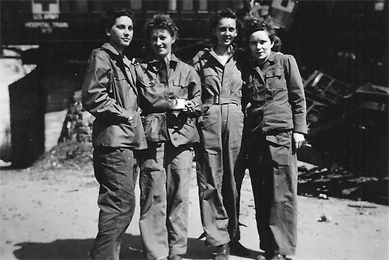 Four Nurses of the 11th Hospital Train pictured in front of train wreckage following the derailment in April, 1945. From L to R: ANC Officers Van Houten, Kenny (Head Nurse), Kennedy, Graham. Courtesy Van P. Keele.