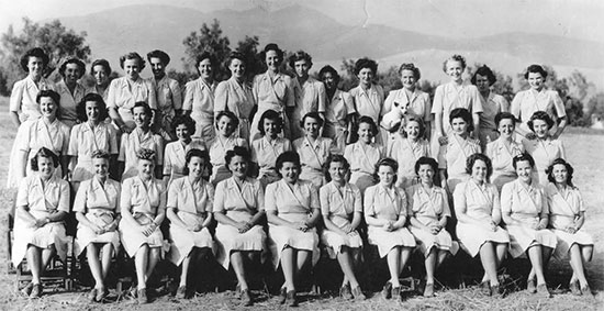 Group photograph showing Nurses of the 11th Evacuation Hospital during training in the ZI. Front row, left to right: Loretta Harris, Cathleen Ligas, Mildred Wells, Margaret Mailloux, Charlotte Johnston, Eleanore Gasline, Charlotte Collier, Waunita Schepper, Muriel Scheckter, Marguerite Hardacre, Doris Watson, Annie Deeds. Middle row, left to right: Helene Gorman, Henrietta Pfeffer, Mildred Taylor, Ernesta Reiff, Dorothy Good, Elizabeth Cook, Louise McElroy, Frances Gilboy, Diana Crosson, Anne Madan, Nellie Musser, Lucille Brown. Back row, left to right: Emelyn Harlow, Virginia Billings, Frances Backer, Catherine Crossan, Eleanor Richey, Bernice Rannells, Lois Pierce, Marjory Frosh, Ida Winchester, Mirian Dunning, Olive Field, Barbara Fraunholz, Ilene LeFevers, Myrtle Costello, Dorothy Woebbeking.