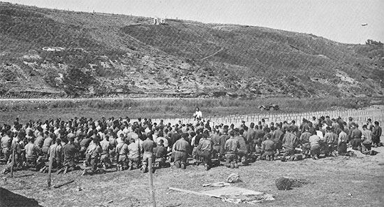 Omaha Beach sector, a Holy Mass is conducted at Saint-Laurent-sur-Mer Cemetery No. 2, following removal of the dead from the temporary Cemetery No. 1, June 24-25, 1944.