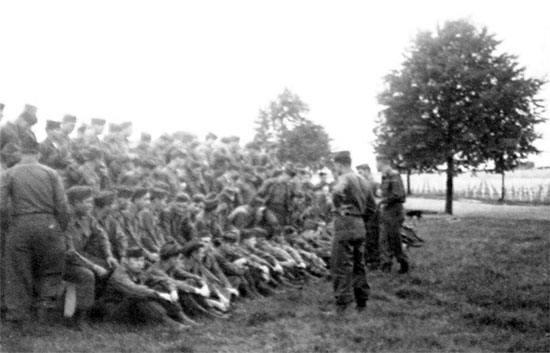 Captain Robert M. Ferrell, Commanding Officer, 603d QM GR Co, holds a briefing in preparation for the Memorial Day celebration to be held at Henri-Chapelle Cemetery, Belgium. 