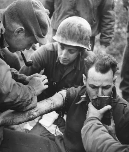 February 1944; Anzio Beachhead, American Hospital Sector. A patient is being treated by a member of the Medical Department.