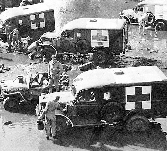 Summer of 1944, France. Personnel of an Ambulance Company take some time to wash and clean their vehicles. 