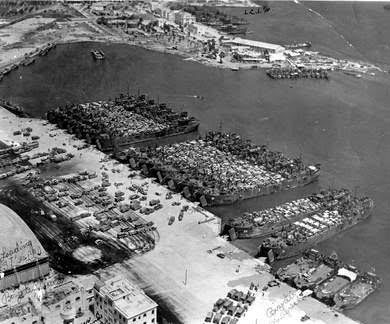 1943; Bizerte harbor area, Tunisia. Landing Ship Tanks are being prepared for Operation “Husky”, the Invasion of Sicily.