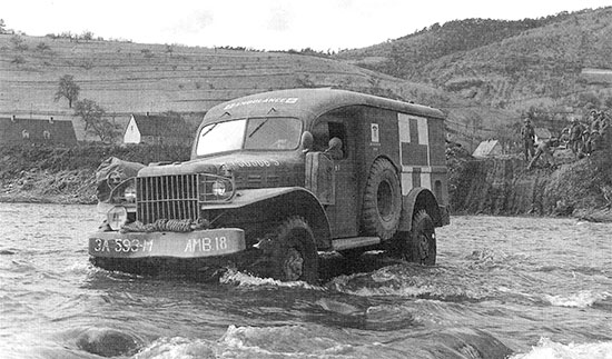 Somewhere in Germany. A 3/4-ton ambulance (WC-54) fords a shallow river (this particular ambulance pertains to the 593d Ambulance Company, Motor).