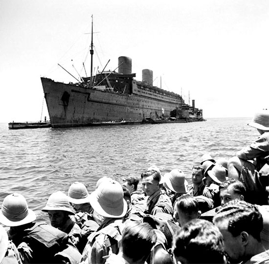 Photo of RMS Queen Elizabeth taken in July 1942. She carried the 12th Evacuation Hospital to the United Kingdom, sailing out of New York POE January 6, 1943 with destination the United Kingdom.
