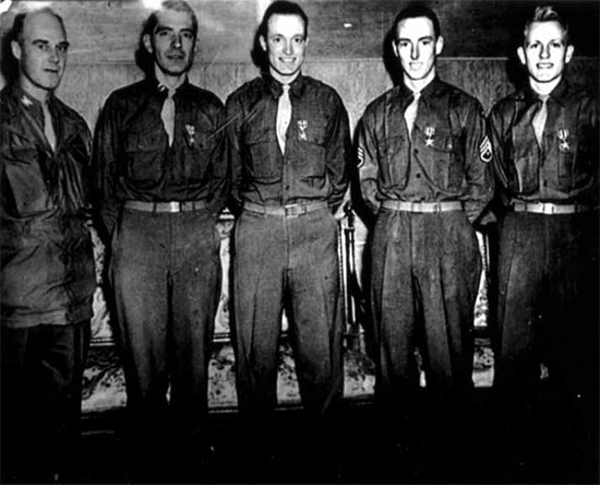 Photo of the 4 members of the 12th Evacuation Hospital showing the men after being awarded the Silver Star. From L to R: Colonel Marshall S. Brown, Jr., CO 12th Evacuation Hospital; Captain Edward N. Zinschlag (General Surgeon), Captain Henry M. Hills (Orthopedic Surgeon), Technician 3d Grade John H. Donohue (Surgical Technician) and Technician 4th Grade Lawrence T. Rethwisch (Surgical Technician). 