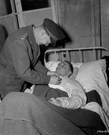 General Dwight D. Eisenhower awarding the DSC and Purple Heart to patient Colonel Dwight T. Colley, November 15, 1944, during the 12th Evacuation Hospital’s stay in Nancy, Lorraine, France.