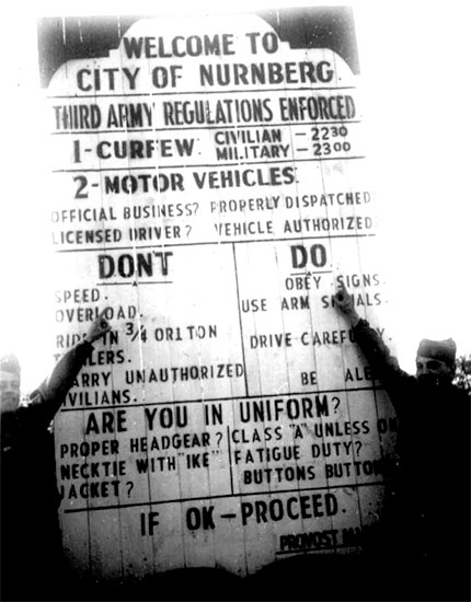 Germany 1945. Signpost detailing regulations enforced by Third United States Army (TUSA) authorities in the City of Nürnberg, Germany.