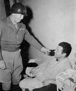 November 22, 1944. Lieutenant General G. S. Patton, Jr., CG Third US Army, visits the 12th Evacuation Hospital to award medals to wounded servicemen.