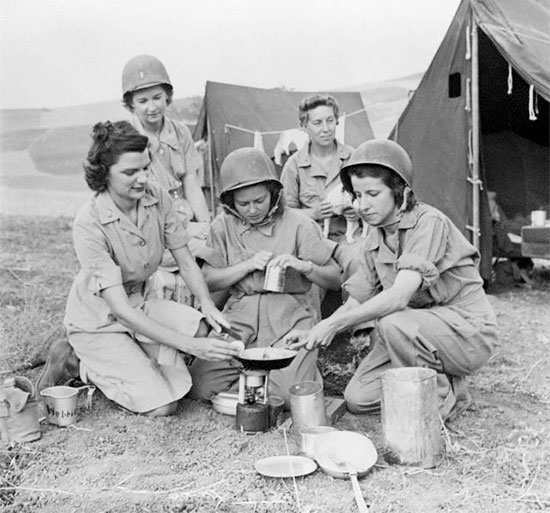 Sicily, 26 July 1943. Photo illustrating some ANC Officers pertaining to the 10th Field Hospital, while indulging in some basic field cooking.