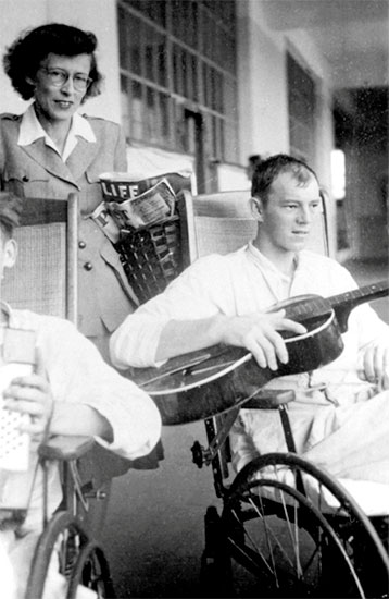 Picture illustrating Miss Barbara L. Ashbaugh, ARC Assistant Field Director, serving with the 25th General Hopital, with patient.