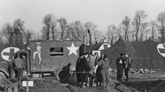 Picture of “Beached Bessie”, a former French ambulance used by the Germans, gift of a US Officer to the ARC. Quite heavily decorated (paintings removed by order of the CO), the vehicle first served as a transport for the American Red Cross contingent, but was later taken over by the 25th General Hospital for use as a mess truck to carry the food to the different wards, being christened “Meals on Wheels”. This vehicle some use during the hospital’s stay at Lison, between August and November 1944.