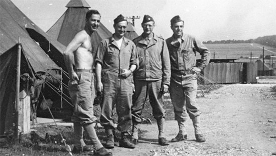 Partial view illustrating some Officers of the 25th General Hospital during their stay near Stockbridge, Hampshire, England, between January and March 1944. Third Officer from left: Major Stanley D. Simon, MC.