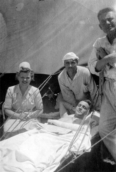 Picture of 1st Lieutenant Vera C. Gustafson, ANC, N-744548, General Duty Nurse with some patients, while the 27th Evacuation Hospital was operating at Maddaloni, Italy.