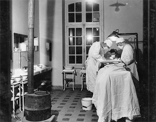 Operating room in action at Baccarat, France, where the 27th Evacuation Hospital. The organization occupied the Caserne Ladmirault where they remained from November 25 to December 17, 1944. Courtesy UIC.