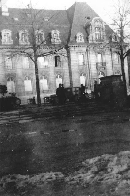 Ambulances and other US Army vehicles pictured in front of the 110th Evacuation Hospital's facility in Esc