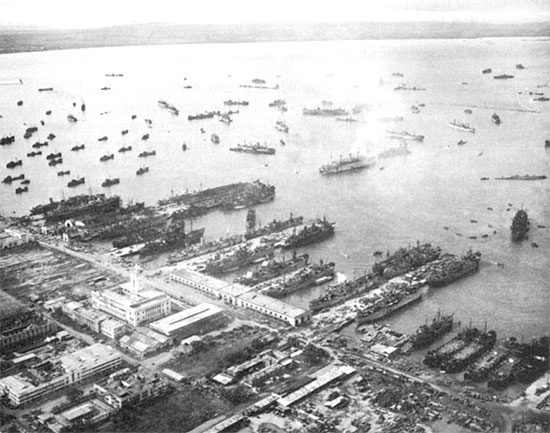 General aerial view of docking facilities and ships at Base X, Manila area, Philippine Islands, 17 September 1945.