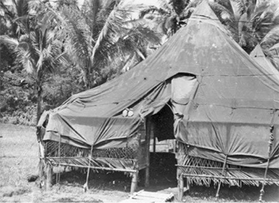 View of an M-1934 Pyramidal Tent set up over a bamboo structure,  as in use with the 80th General Hospital.