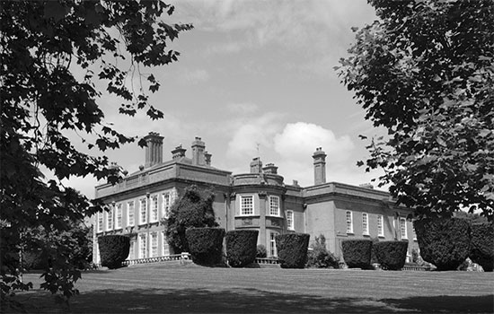 Partial view of “Fremington House” (3 miles west of Barnstaple), Fremington, Devonshire. The 3-story brick construction was used for quarters and messing by the ANC Officers assigned to the 313th Station Hospital.