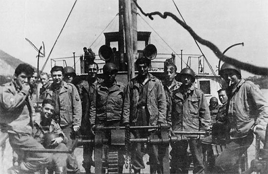 Picture illustrating some personnel of the 60th Field Hospital aboard a ship. This could well be the Moselle or the Rhine rivers. The person identified by the arrow left, is Louis Loffredo, 32905282. 